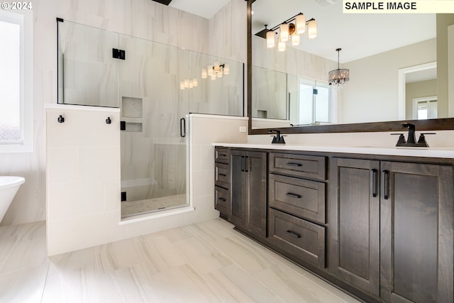 bathroom with dual sinks, oversized vanity, tile flooring, a healthy amount of sunlight, and an enclosed shower