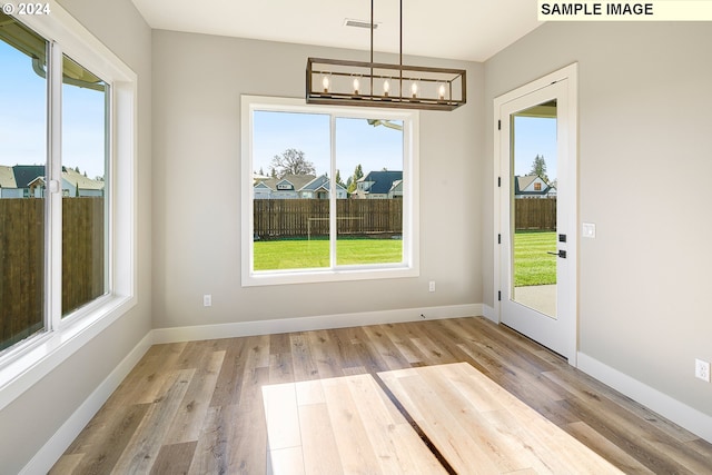 interior space with a chandelier and light wood-type flooring