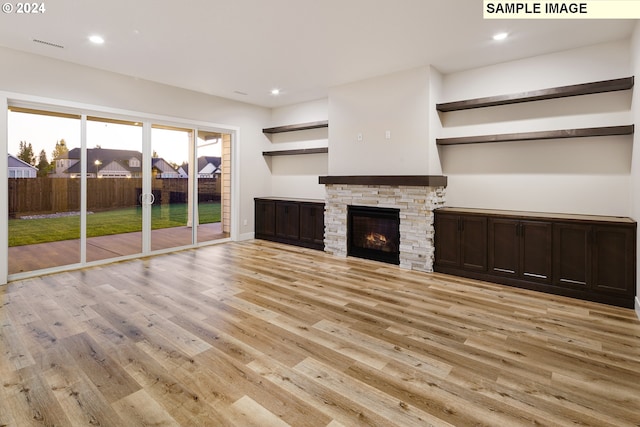 unfurnished living room with light hardwood / wood-style floors and a fireplace