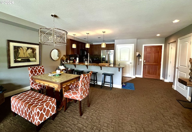 carpeted dining area with a textured ceiling and an inviting chandelier