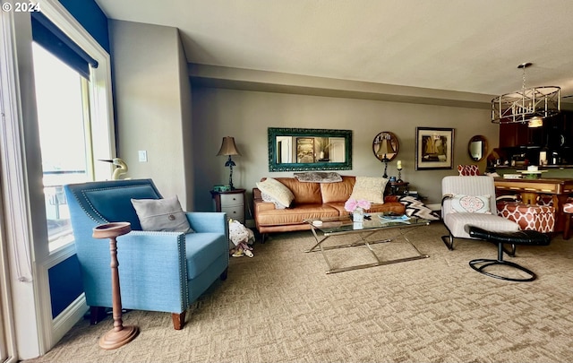 carpeted living room with a notable chandelier