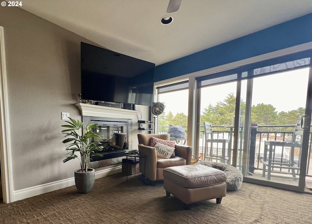 sitting room featuring ceiling fan and carpet