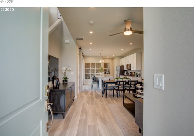 interior space with a barn door and light wood-type flooring