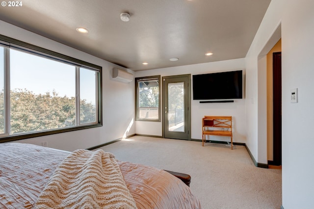 bedroom featuring an AC wall unit, light carpet, and access to outside