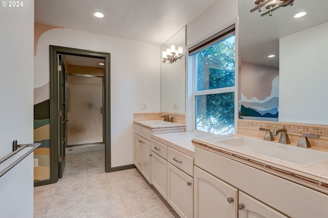 bathroom featuring vanity, an inviting chandelier, tile patterned flooring, decorative backsplash, and an enclosed shower