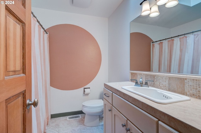 bathroom featuring decorative backsplash, vanity, tile patterned floors, and toilet