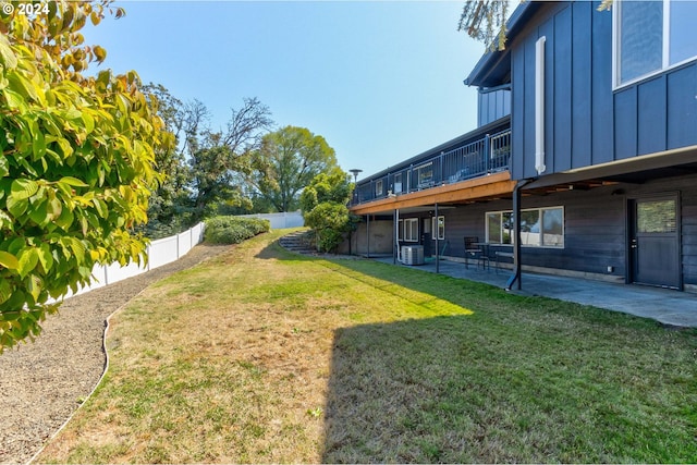 view of yard with central air condition unit and a patio