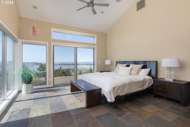 bedroom with a water view, ceiling fan, high vaulted ceiling, and multiple windows