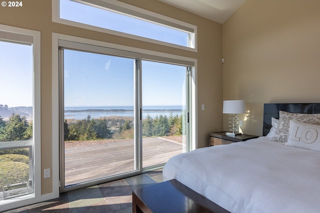 bedroom with multiple windows and a water view