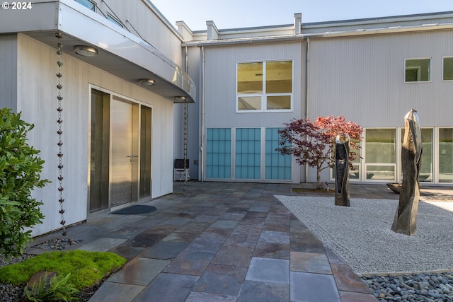 view of exterior entry featuring a patio area