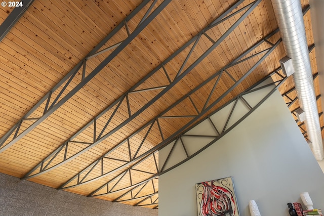 room details featuring beamed ceiling, carpet floors, and wooden ceiling