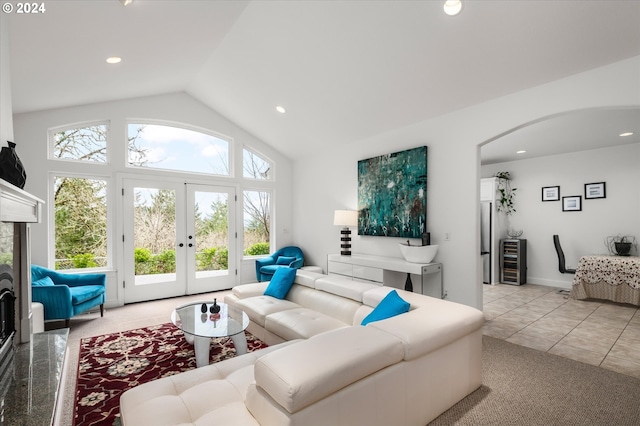 tiled living room with vaulted ceiling, a premium fireplace, wine cooler, and french doors