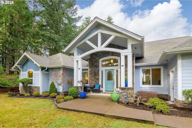 view of exterior entry with a yard