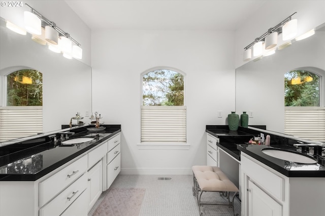 bathroom featuring tile patterned flooring and vanity