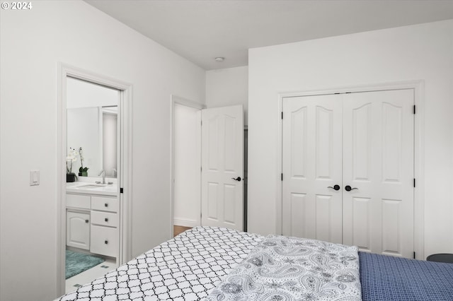 bedroom featuring sink and a closet