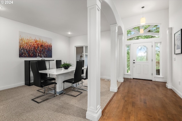 entryway featuring carpet flooring and ornate columns