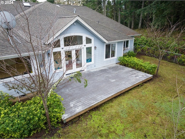 wooden terrace featuring a lawn