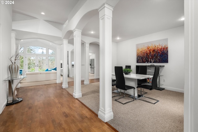 home office with french doors, hardwood / wood-style floors, and lofted ceiling