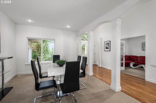 carpeted dining area featuring ornate columns