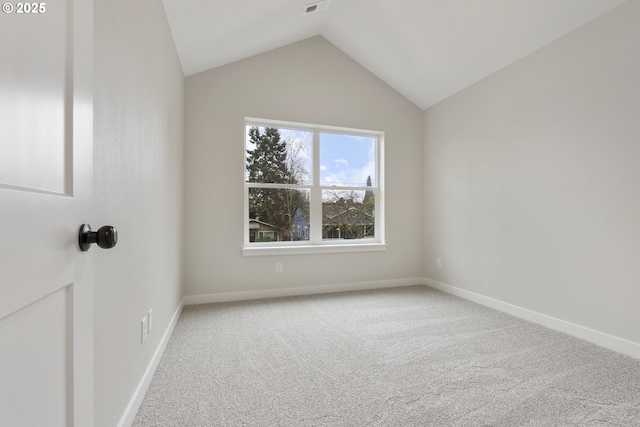 unfurnished room with carpet and vaulted ceiling