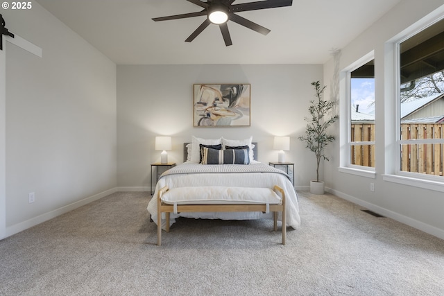 bedroom featuring ceiling fan and carpet