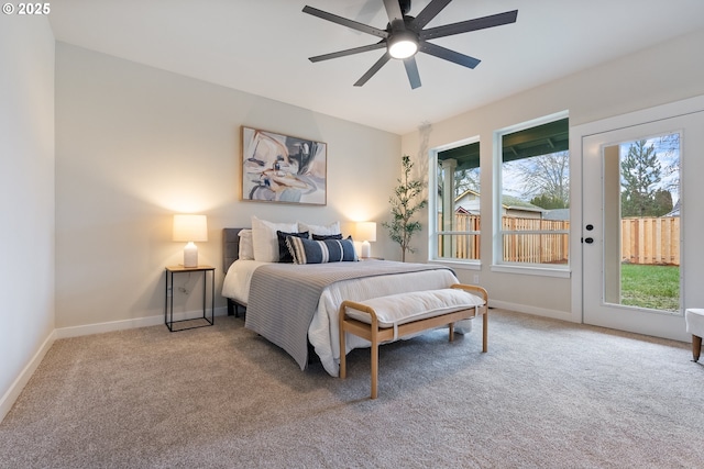 carpeted bedroom with ceiling fan, multiple windows, and access to outside