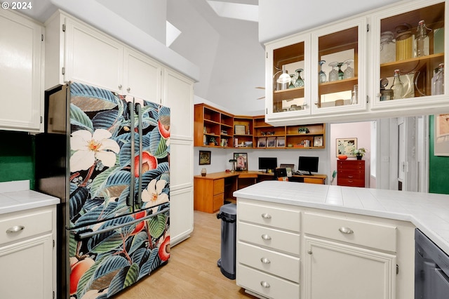 kitchen featuring white cabinetry, light hardwood / wood-style flooring, and tile counters