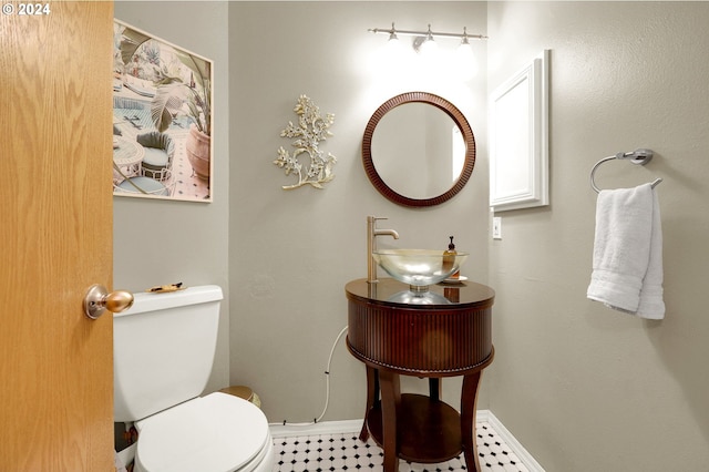 bathroom featuring toilet and sink