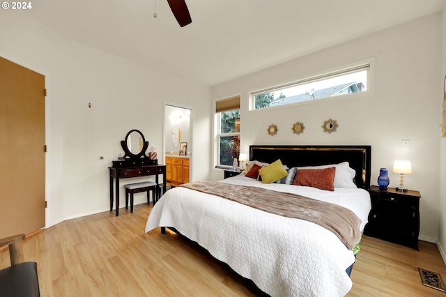 bedroom with ceiling fan, connected bathroom, and light hardwood / wood-style flooring