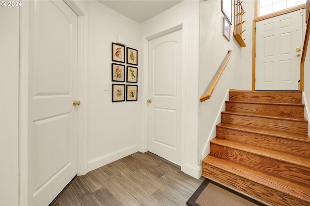 stairs featuring hardwood / wood-style floors