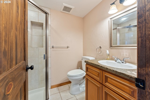 bathroom with vanity, a shower with shower door, toilet, and tile patterned floors