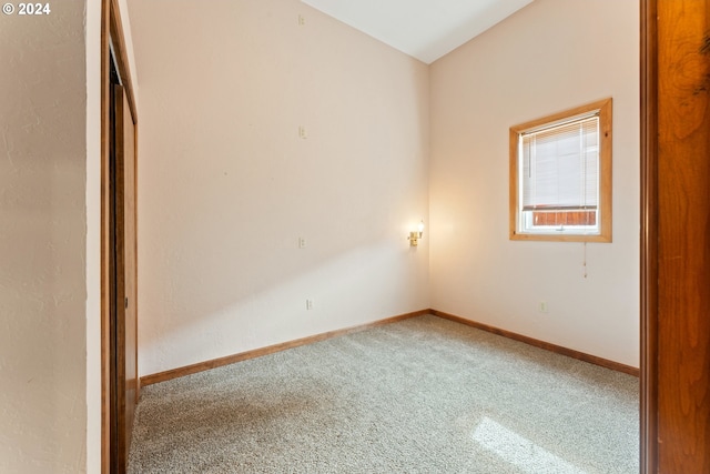 carpeted empty room with baseboards