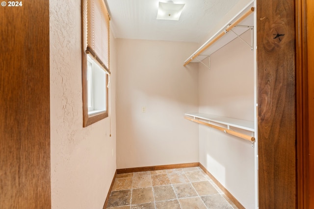 spacious closet with stone finish floor