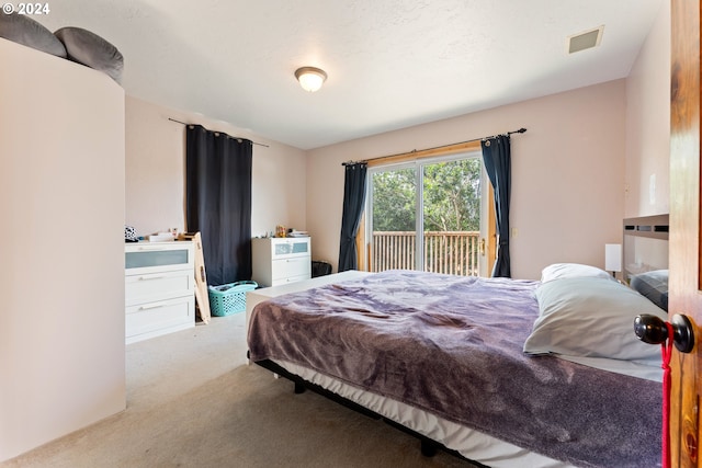 bedroom featuring carpet flooring, visible vents, and access to exterior