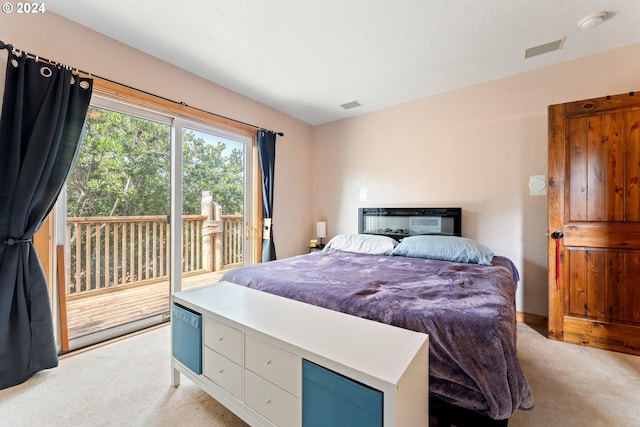 bedroom with access to exterior, visible vents, and light colored carpet