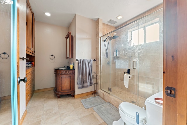 bathroom featuring visible vents, baseboards, toilet, vanity, and a shower stall