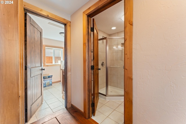 hallway featuring light tile patterned floors