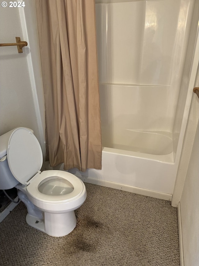 bathroom featuring shower / bath combo and toilet