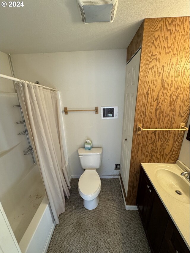 full bathroom featuring vanity, shower / tub combo, and toilet