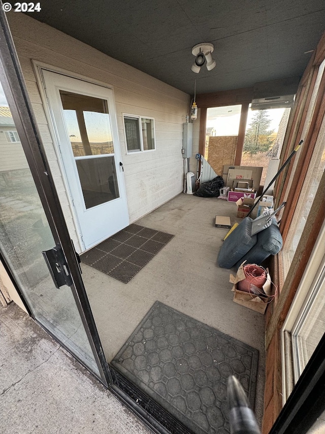 unfurnished sunroom featuring electric panel