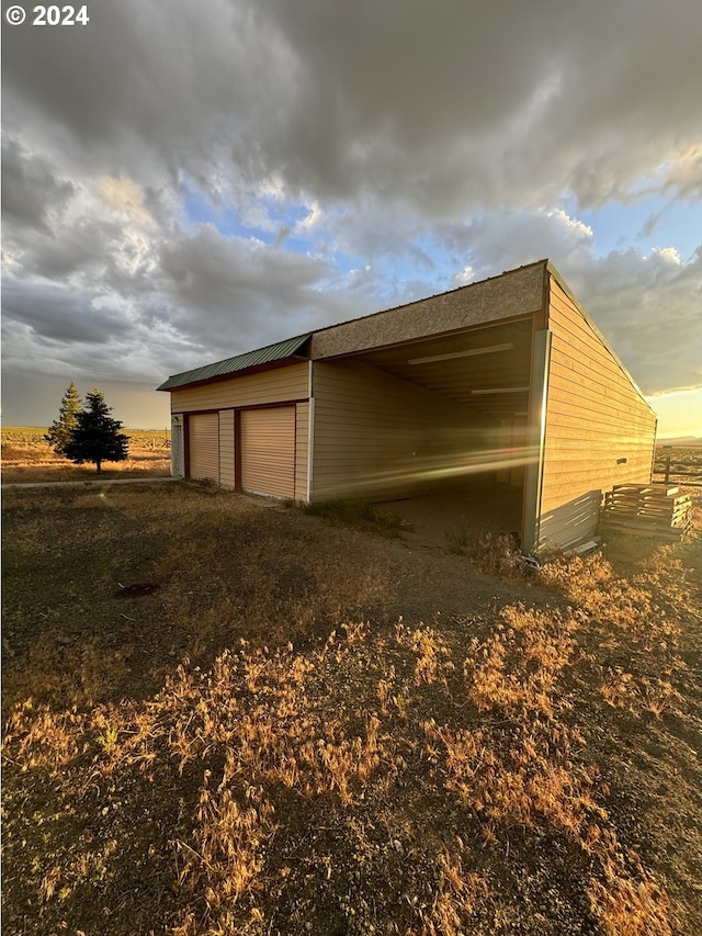 exterior space featuring a garage and an outdoor structure