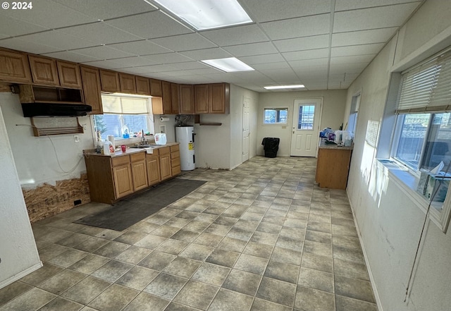 kitchen featuring sink, a drop ceiling, and water heater