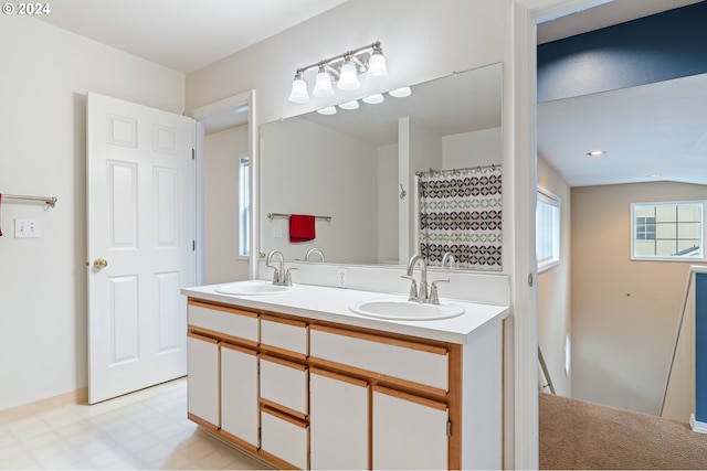 bathroom with vanity and lofted ceiling