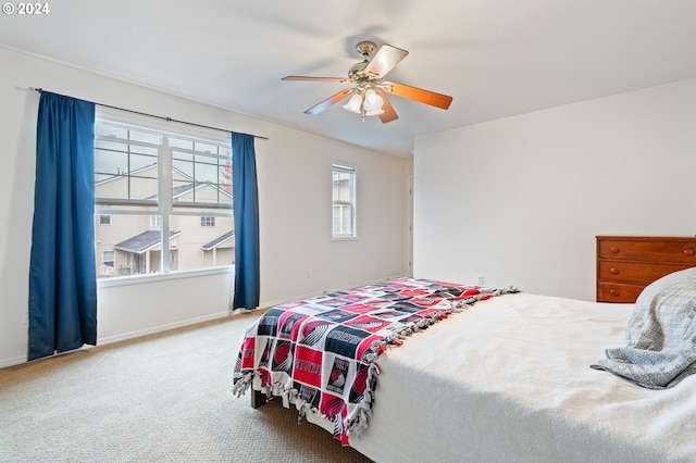 bedroom featuring ceiling fan and carpet