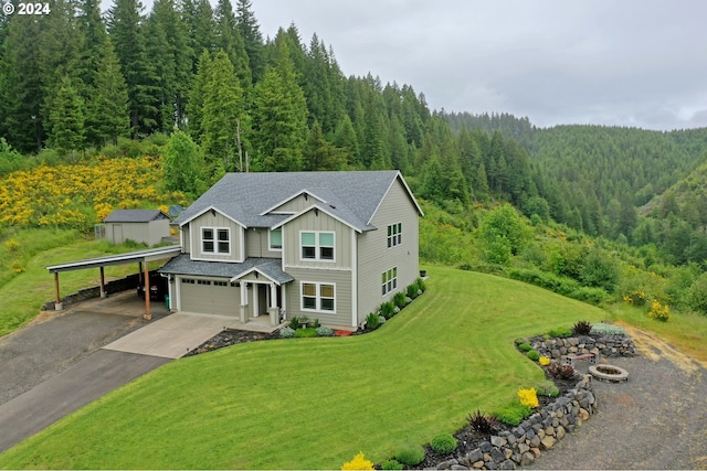 view of front of property with a carport, a garage, and a front yard