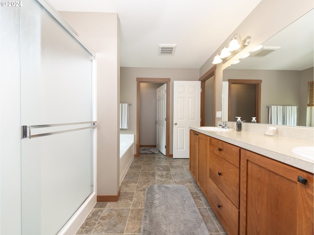 bathroom with vanity and independent shower and bath