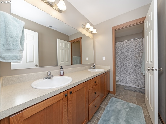 bathroom featuring vanity, tile patterned flooring, and toilet