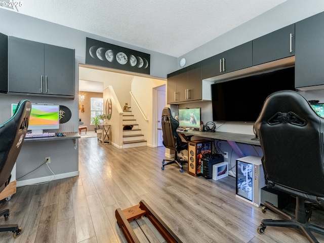 office area featuring a textured ceiling and light hardwood / wood-style flooring