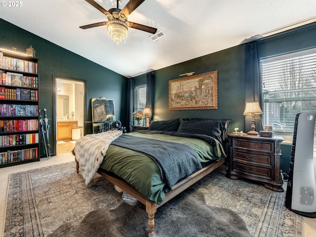 bedroom featuring lofted ceiling, ceiling fan, and multiple windows