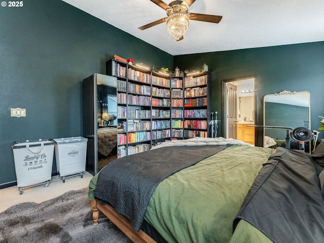 bedroom featuring ceiling fan, ensuite bathroom, lofted ceiling, and carpet floors